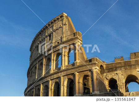 Famous Coliseum in Rome. Colosseum, or Coliseum. Sunset at huge Roman amphitheatre, Rome, Italy, Europe. Famous touristic place in the world and Europe. Beautiful blue sky background. Famous Coliseum in Rome. Colosseum, or Coliseum. Sunset at huge Roman amphitheatre, Rome, Italy, Europe. Famous touristic place in the world and Europe. Beautiful blue sky background. 135561847