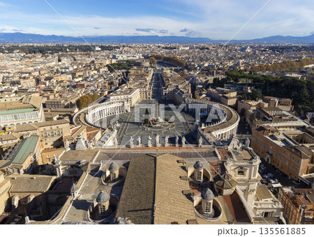 Panoramic view of Vatican City and Rome from St. Peter's Basilica dome offering an expansive. St. Peter's Square Rome panoramic cityscape. View from dome of St. Peters Basilica. Popular tourist place. Panoramic view of Vatican City and Rome from St. Peter's Basilica dome offering an expansive. St. Peter's Square Rome panoramic cityscape. View from dome of St. Peters Basilica. Popular tourist place. 135561885