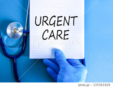 Urgent care symbol. Concept words Urgent care on beautiful white note. Doctor's hand in blue medical glove. Stethoscope. Beautiful blue background. Medical healthy lifestyle urgent care concept. 135561929