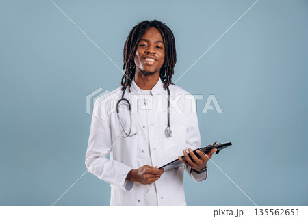 Doctor with stethoscope. Black man is in the studio against soft background 135562651
