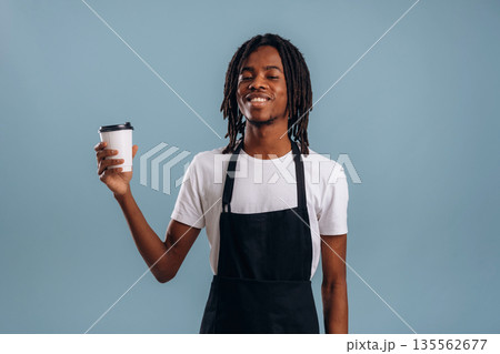 Barista is with coffee. Black man is in the studio against soft background 135562677