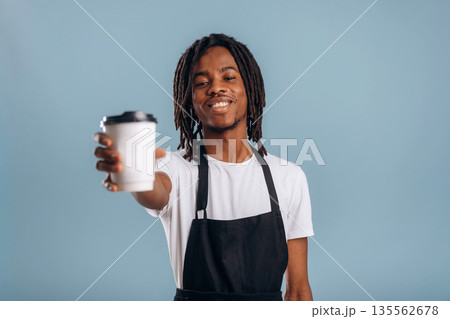 Barista is with coffee. Black man is in the studio against soft background 135562678