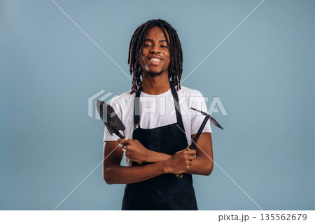 Gardener is ready to work. Black man is in the studio against soft background 135562679