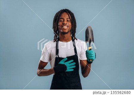 Gardener is ready to work. Black man is in the studio against soft background 135562680