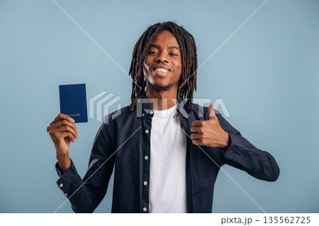 Tourist is with passport. Black man is in the studio against soft background 135562725