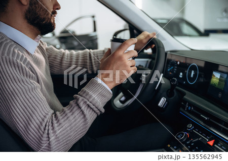 Side view. Man is sitting in car, detailed view 135562945