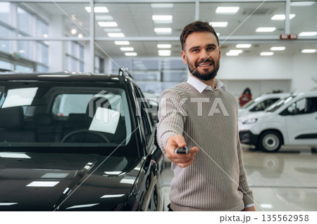 Keys for new automobile. Man is with the car in dealership 135562958