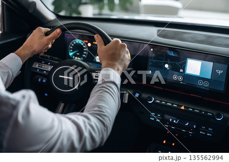 View from behind. Man is sitting in car, detailed view View from behind. Man is sitting in car, detailed view 135562994