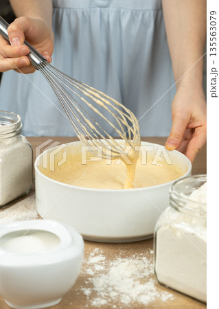 Texture of batter for baking, dough dripping from whisk close-up. Texture of batter for baking, dough dripping from whisk close-up. 135563079