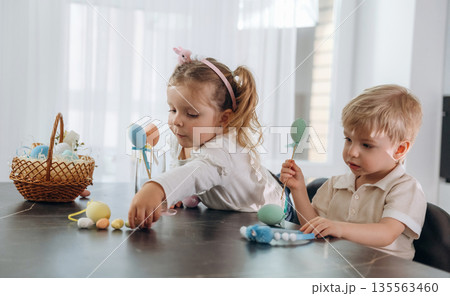 Easter conception. Kids are preparing bakery at home Easter conception. Kids are preparing bakery at home 135563460