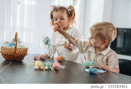 Easter conception. Kids are preparing bakery at home Easter conception. Kids are preparing bakery at home 135563461