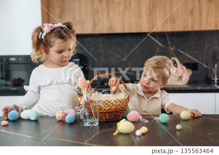 Easter conception. Kids are preparing bakery at home Easter conception. Kids are preparing bakery at home 135563464