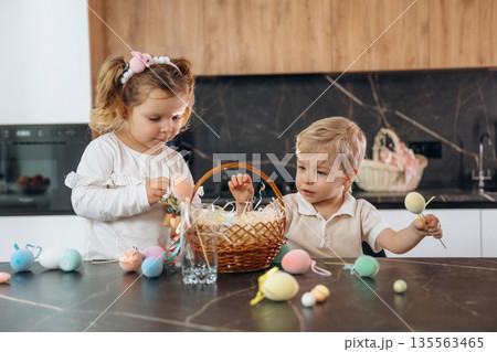 Colorful eggs for Easter. Kids are preparing bakery at home Colorful eggs for Easter. Kids are preparing bakery at home 135563465