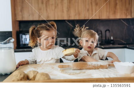 Sister and brother. Kids are preparing bakery at home Sister and brother. Kids are preparing bakery at home 135563591