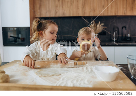Cooking process. Kids are preparing bakery at home 135563592
