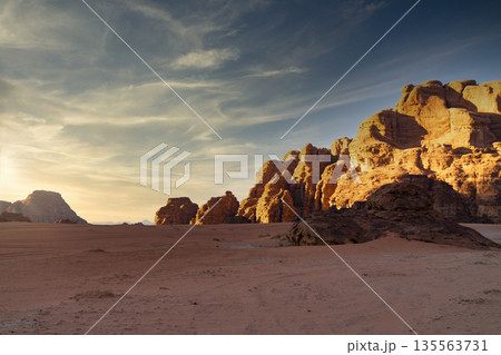 Wadi Rum desert, Jordan, The Valley of the Moon. Landscape with rocks and mountains at sunset. Wadi Rum desert, Jordan, The Valley of the Moon. Landscape with rocks and mountains at sunset. 135563731