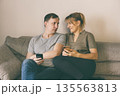Man and woman holding smartphones 135563813