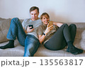 Man and woman holding smartphones 135563817