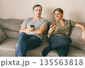 Man and woman holding smartphones 135563818