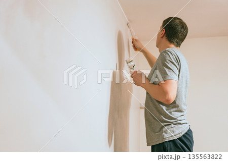 Man painting walls Man painting walls 135563822
