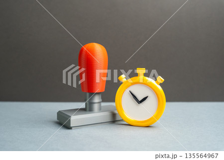 Stopwatch and office seal. Permits and document verification. Administrative timing pressure, approval deadlines and compliance checks. Bureaucratic efficiency, legal validation and control 135564967