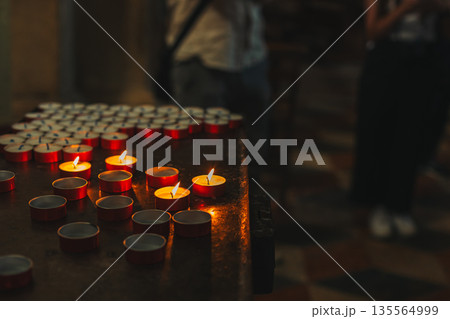 Burning candles in an old church. Selective focus. 135564999