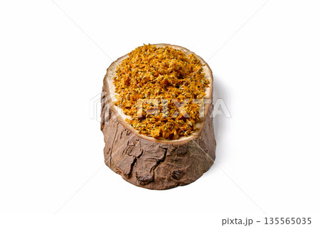 pressed and dried sea buckthorn berries with seeds on a wooden board on a white background. pressed and dried sea buckthorn berries with seeds on a wooden board on a white background. 135565035