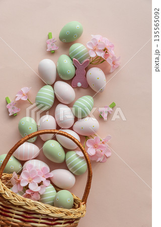 Easter Basket with Pastel Eggs, Flowers and Bunny Decorations. Festive Spring Flatlay Easter Basket with Pastel Eggs, Flowers and Bunny Decorations. Festive Spring Flatlay 135565092