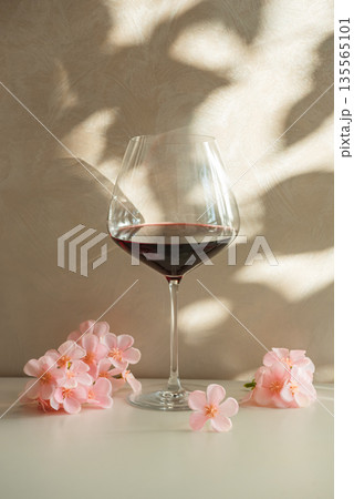 Red Wine Glasses with Sakura  Cherry Blossoms. Elegant Spring Still Life 135565101
