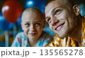 Smiling father and bald child sharing joyful moment, symbolizing family support during illness recovery 135565278