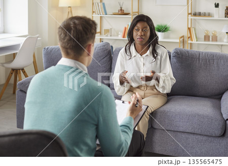 Psychotherapist With Sad Patient In Therapy Session Psychotherapist With Sad Patient In Therapy Session 135565475