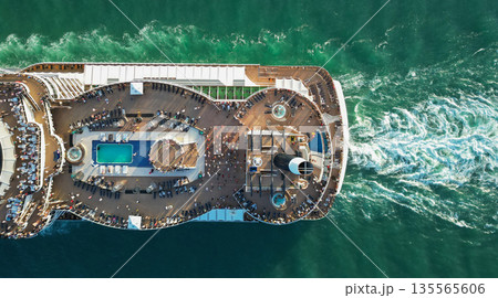 Luxury liner resort. Cruise ship voyage. Aerial top view of cruise in summer vacation. Cruise ship tour and travel at sea. Aerial view of luxury liner voyage. Ship top view. Elegant cruise Luxury liner resort. Cruise ship voyage. Aerial top view of cruise in summer vacation. Cruise ship tour and travel at sea. Aerial view of luxury liner voyage. Ship top view. Elegant cruise 135565606