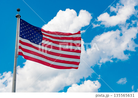 American flag waving for independence day. Flag of the USA. National waving flag of united states on blue sky. Independence day. Patriotic symbol. American Flag for Memorial Day or 4th of July American flag waving for independence day. Flag of the USA. National waving flag of united states on blue sky. Independence day. Patriotic symbol. American Flag for Memorial Day or 4th of July 135565631