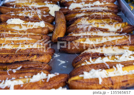 Plantain stuffed and fried. Ecuadorian food of baked ripe banana stuffed with cheese. Baked ripe stuffed banana. Traditional dish plantain canoe. Hot fried plantain slices, picnic style Plantain stuffed and fried. Ecuadorian food of baked ripe banana stuffed with cheese. Baked ripe stuffed banana. Traditional dish plantain canoe. Hot fried plantain slices, picnic style 135565657