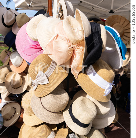 Straw hat store at market tourist shopping district. Street market selling hat and souvenir in the touristic place. Shopping accessory. Straw hat market. Straw hat on a street market souvenir shop 135565658