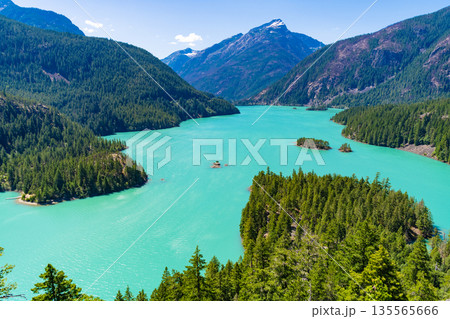 Landscape of mountain peak and Diablo lake. Nature landscape. Diablo Lake in North Cascades National Park. Scenic nature view at Diablo lake. Diablo lake with mountain landscape. Emerald water Landscape of mountain peak and Diablo lake. Nature landscape. Diablo Lake in North Cascades National Park. Scenic nature view at Diablo lake. Diablo lake with mountain landscape. Emerald water 135565666