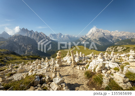Sunset landscape of the Dolomites near Tre Cime with alpine meadows and dramatic peaks 135565699