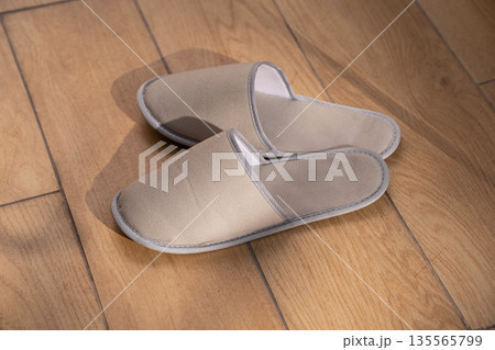 A pair of hotel slippers on the parquet floo 135565799