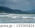 Blue sea with waves on rocks and hills 135565824
