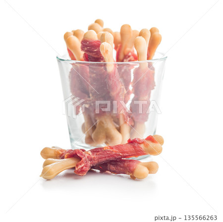 Dog food. Snack sticks for dogs isolated on white background. 135566263