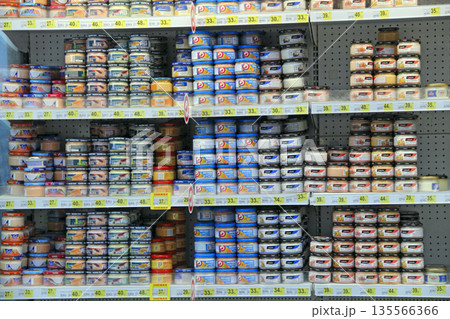 variety of salmon caviar with various additives sold on shelves of supermarket 135566366