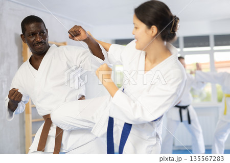 Multinational pupils train to perform defensive karate installations and attacking combat techniques Multinational pupils train to perform defensive karate installations and attacking combat techniques 135567283