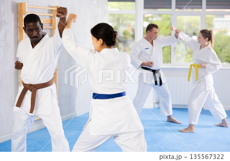 Multinational pupils train to perform defensive karate installations and attacking combat techniques Multinational pupils train to perform defensive karate installations and attacking combat techniques 135567322