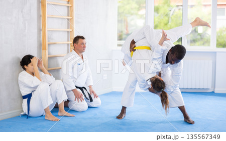 Multinational athletes in pair conduct training battle in oriental fighting technique 135567349