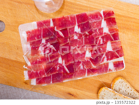 Sliced cured ham served on board Sliced cured ham served on board 135572322
