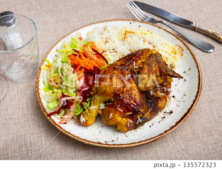 Delicious chicken dish with salad and rice Delicious chicken dish with salad and rice 135572323