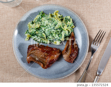 Fried veal with pasta and sauce 135572324