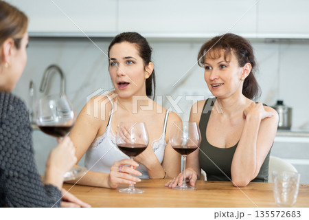 Three women have nice chat-in with wine and conversation Three women have nice chat-in with wine and conversation 135572683