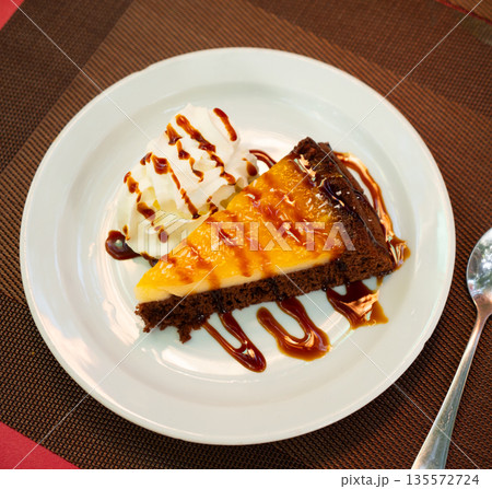 Slice of orange cake served for dessert 135572724