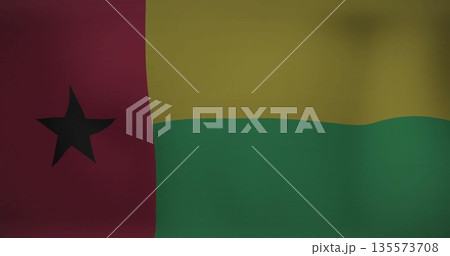Displaying national flag of Guinea-Bissau fluttering against neutral plain backdrop, fabric detail 135573708